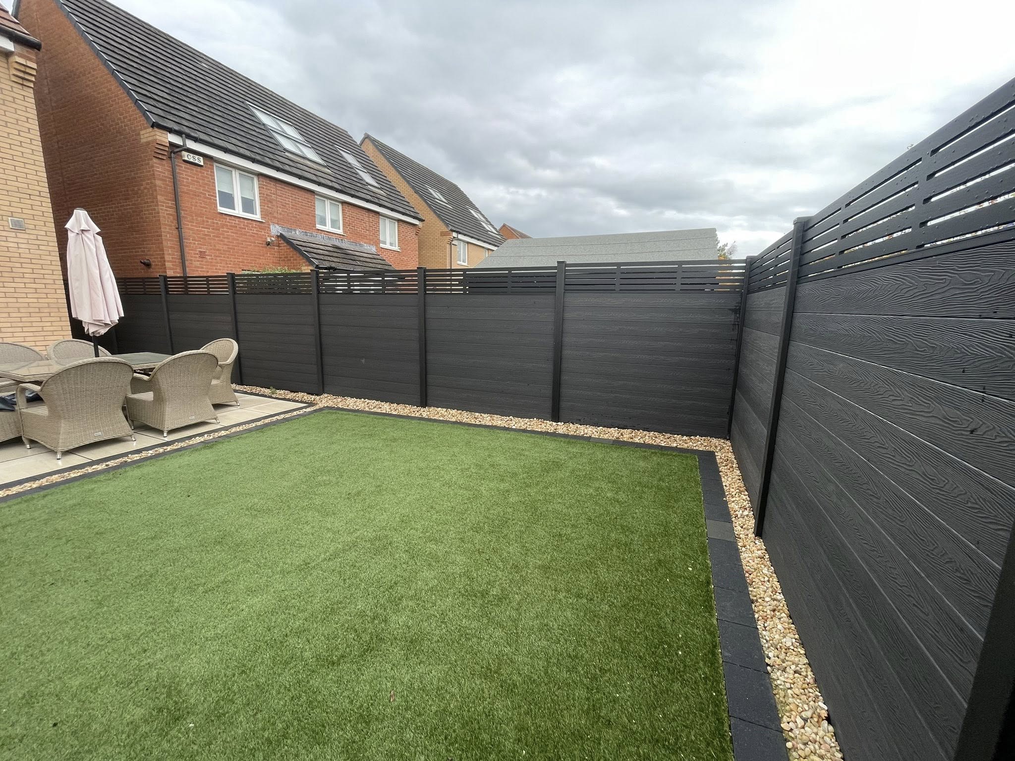 47m of composite fencing with 2 bespoke gates featuring dark grey slats, black composite and aluminium posts, black trellis, trims and caps in Greater Glasgow
